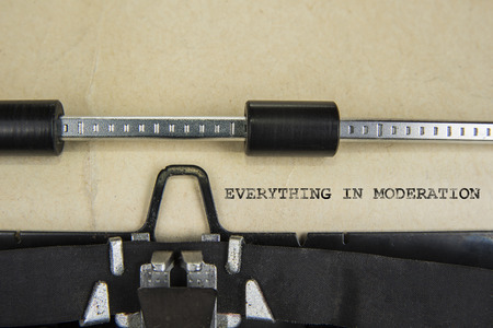 Motivation sign Everything in Moderation written on old typewriterの写真素材