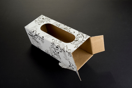 Empty cardboard box with ornaments and the holeの写真素材