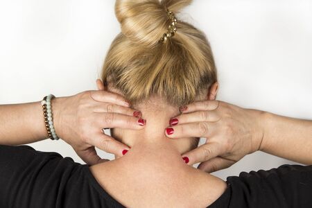 Mature women with neck pain. Self massage conceptの写真素材