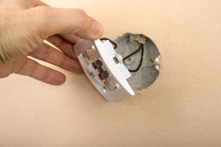 White electric switch with on a wall and without cover