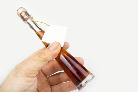 Decorative glass alcohol bottle with a  tagの写真素材