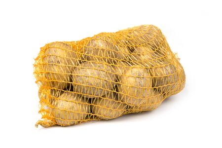 Potato in the mesh net bag on a whiteの写真素材