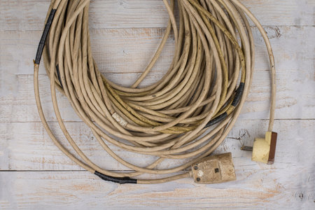 Heavy used  repaired extention cable on a wood
