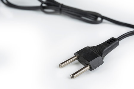 220 volt plug detail with cord on a white