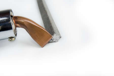 Soldering tin tool with a bar on a whiteの写真素材