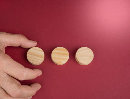 Blank wooden circles for conceptual sign on a redの写真素材