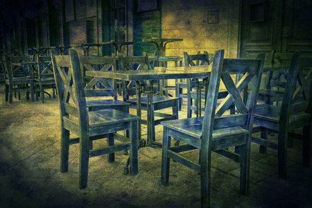 Empty chairs and table in the bar on grunge background