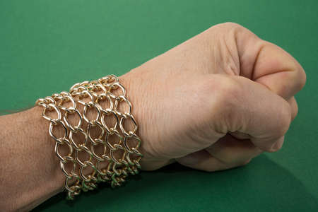 Gold chain around the male wrist. Welth conceptの写真素材