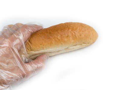 Man holding bread in a hygienic gloveの写真素材