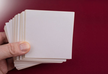 Man holding white note papers on redの写真素材