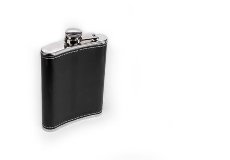 Metal hip flask in leather on a whiteの写真素材