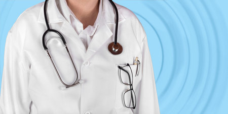 Female doctor in a white coat with a stethoscope in the hand