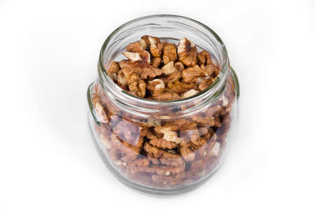 Jar full of walnuts on a white backgroundの写真素材