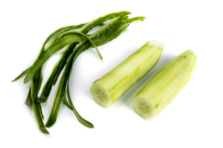 Peel off cucumbers and peels on a white backgroundの写真素材