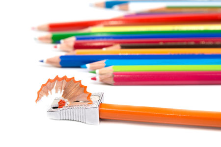 Pencil sharpener with pencil shavings on white