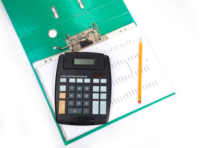 Open file with calculator and pencil. Bookkeeping concept