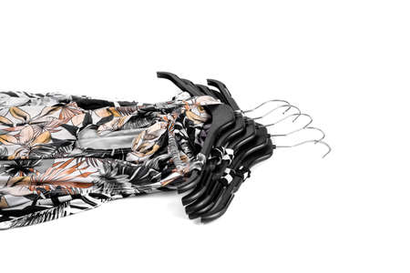 Stack of dresses on hangers on a whiteの写真素材