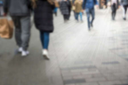 Blurry street with walking people. Bursting rays light.の写真素材