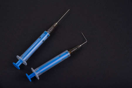 Bent needle on the shot on a black backgroundの写真素材