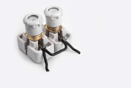 Old porcelain fuse with a holder on a white backgroundの写真素材