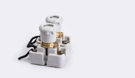 Old porcelain fuse with a holder on a white backgroundの写真素材