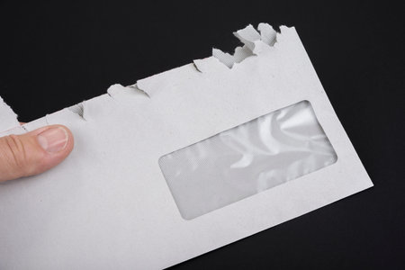 Sloppy opened envelope on a black background