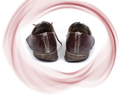 Old dirty shabby shoes on a white background
