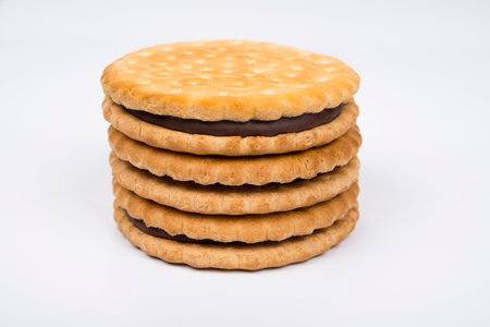 Crispy sandwich biscuits with fluffy cream on a white