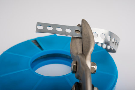 Perforated galvanized steel strip on a whiteの写真素材
