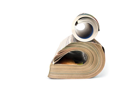 Rolled up magazines on a white backgroundの写真素材