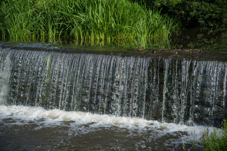 Man made cascade in the creek in the summerの写真素材
