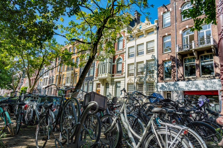 Lots of bicycles on the colonial traditional building in Amsterdamの写真素材
