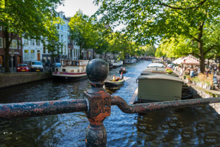 Traditional Amsterdam canal with boats houseboats and bridgesの写真素材