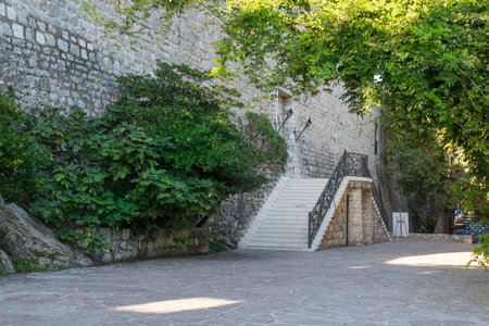 Orthodox and Catholic churches in Budva old Town. Citadela  wooden entrance door and staircaseの写真素材