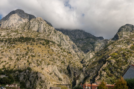 Walls of the Kotor Fortress with mountains and blue sky, Montenegroの写真素材