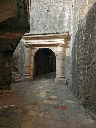 Arched passage way in the traditional medieval stone city walls of Old Townの写真素材