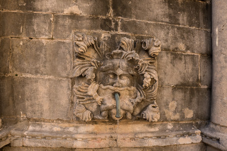 Water faucet in medieval town with a ornamentの写真素材