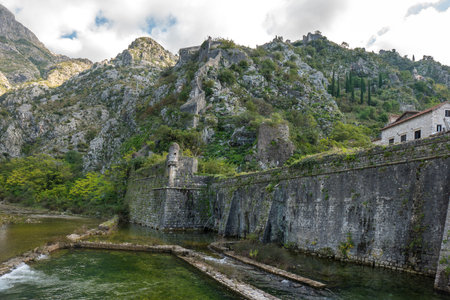 Walls of the Kotor Fortress with mountains and blue sky, Montenegroの写真素材