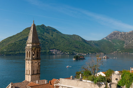 Turquoise water at Perast bay. Our Lady Of The Rocks And The Island Of Saint George. Bell Tower of the Church of St. Nicholasの写真素材