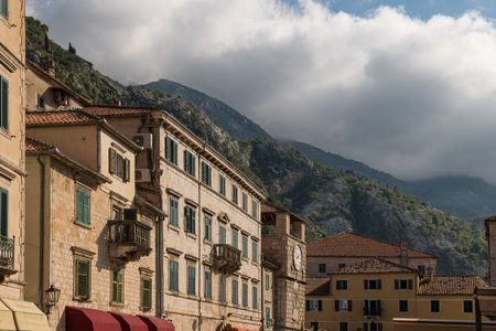 Kotor old town houses surrounding rock mountain and cloudyの写真素材