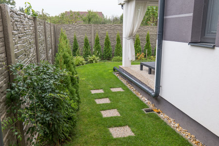 Gutter Downspout Placement into the garden. Rain water use in your houseの写真素材