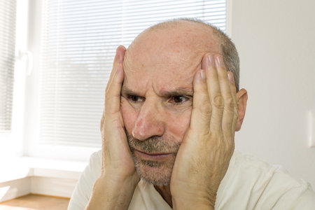 Unhappy lonely senior man in home. Retirement and loneliness conceptの写真素材