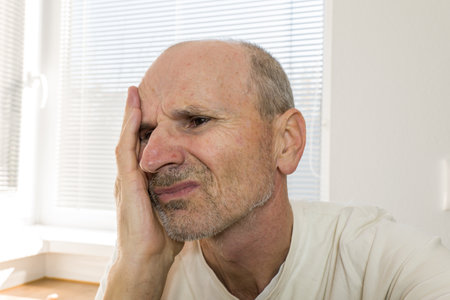 Unhappy lonely senior man in home. Retirement and loneliness conceptの写真素材