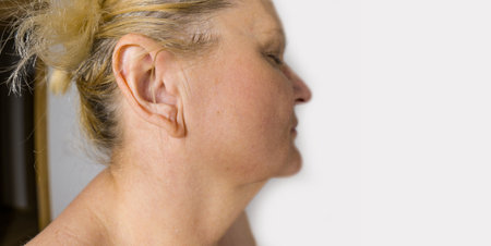 Profile of woman in her sixties with an ear. White Senior female.の写真素材