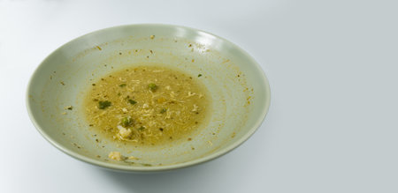 Dirty food waste in a plate on white backgroundの写真素材