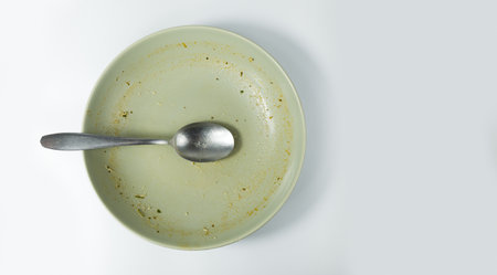 Dirty food waste in a plate on white backgroundの写真素材