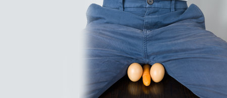 Eggs and carrot as a symbol of man's balls and penis. Diseases of the male genitourinary system.の写真素材