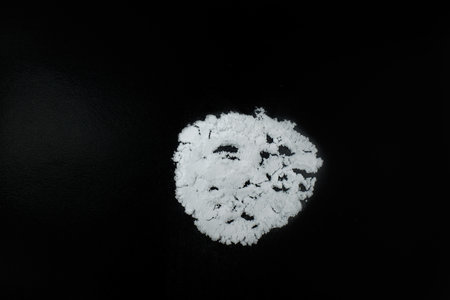 White unknown powder on a black backgroundの写真素材