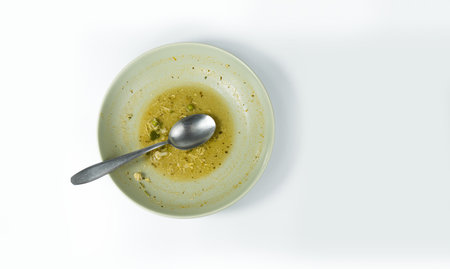 Dirty food waste in a plate on white backgroundの写真素材