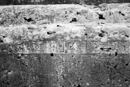 This is a Old greek writing in the ruins of the Syracuse greek theaterの写真素材